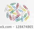 Colorful paper clips made of galvanized steel wire and plastic on white background. 128474865