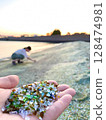 Glass fragments scooped up on glass beach 128474981