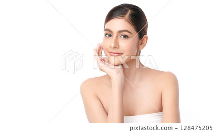 A beautiful young Asian woman with clean, fresh skin against a white background. Skincare, facial treatment, cosmetology, beauty, and spa. An elegant portrait of an Asian woman. 128475205