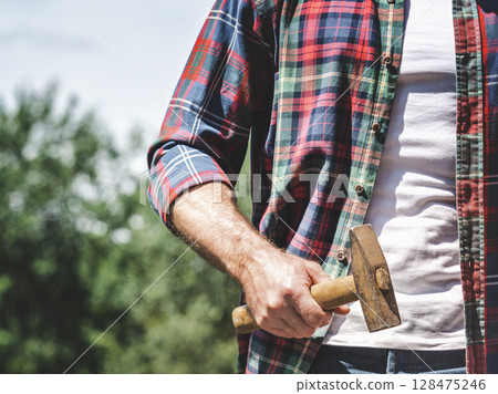 Attractive man and hammer 128475246