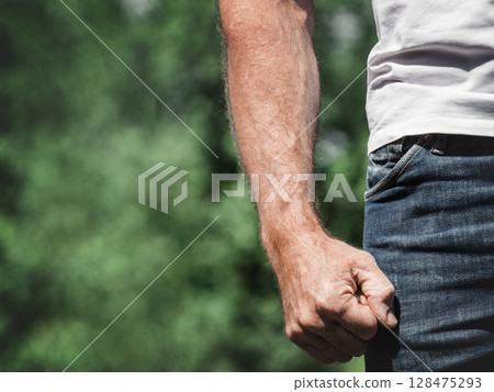 Attractive man, clenched fist and work clothes 128475293