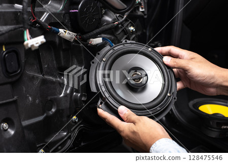 Technician installing the car speaker 128475546