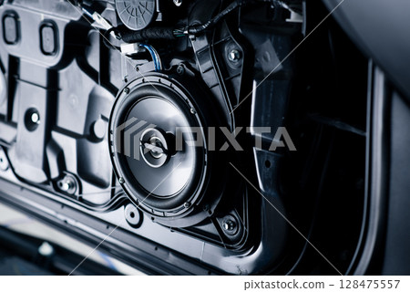 Technician installing the car speaker Technician installing the car speaker 128475557