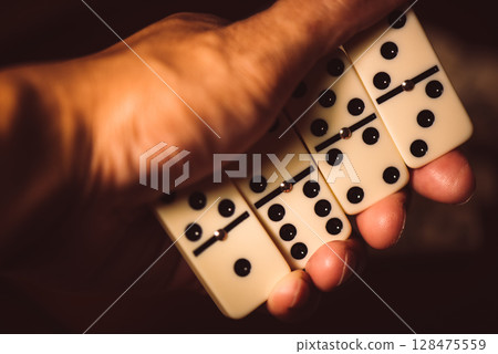 Domino tiles in hand 128475559