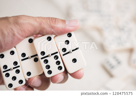 Domino tiles in hand 128475575