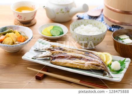 Steaming Japanese breakfast: Grilled fish (filleted saury), rice and miso soup on a table Steaming Japanese breakfast: Grilled fish (filleted saury), rice and miso soup on a table 128475888