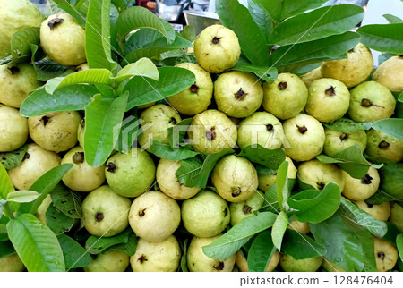 Fresh Ripe Guavas with Leaves Displayed at Local Market Fresh Ripe Guavas with Leaves Displayed at Local Market 128476404
