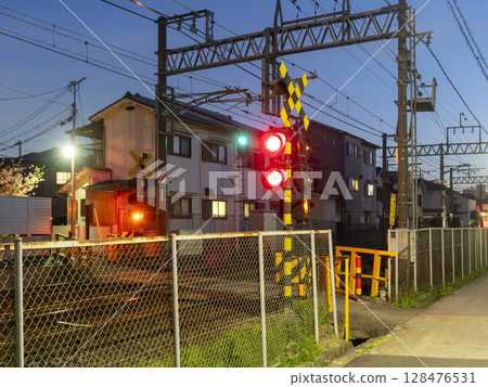 A brightly lit railroad crossing alarm 128476531