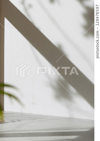 Concrete texture background with shadows from natural light streaming through a window. Concrete texture background with shadows from natural light streaming through a window. 128476597