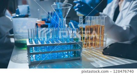 Scientist pipetting medical samples into microplate in laboratory Scientist pipetting medical samples into microplate in laboratory 128476740