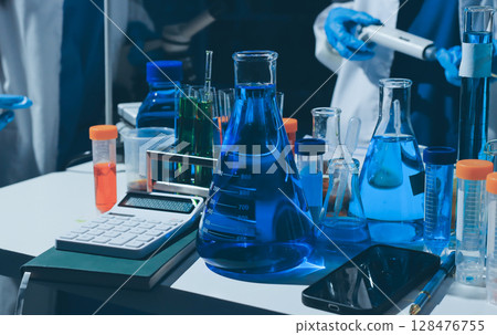 Scientist pipetting medical samples into microplate in laboratory Scientist pipetting medical samples into microplate in laboratory 128476755