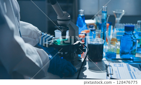 Scientist pipetting medical samples into microplate in laboratory Scientist pipetting medical samples into microplate in laboratory 128476775