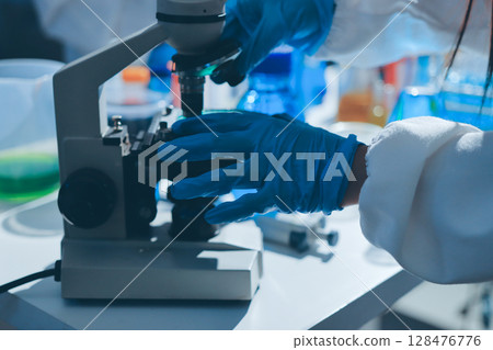 Scientist pipetting medical samples into microplate in laboratory Scientist pipetting medical samples into microplate in laboratory 128476776