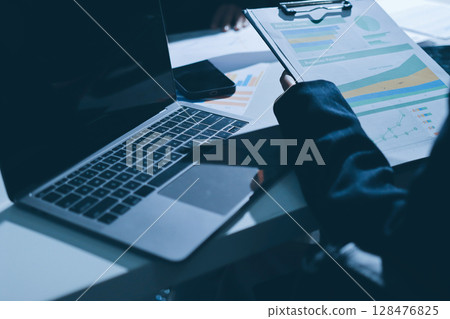 Group of business women working on a financial data expenses document. 128476825