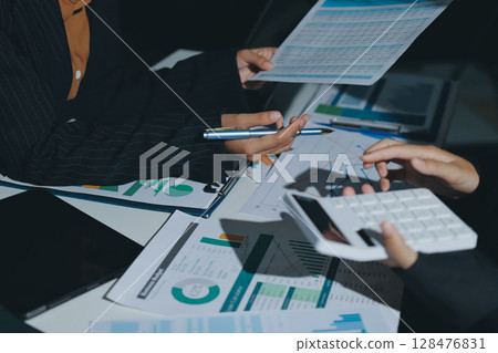 Group of business women working on a financial data expenses document. 128476831