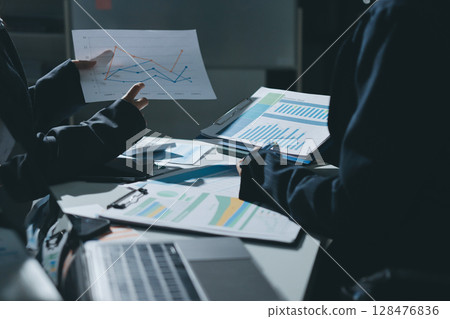Group of business women working on a financial data expenses document. 128476836