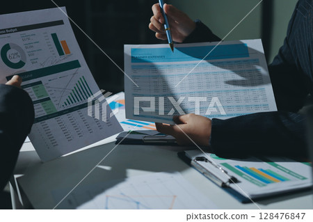 Group of business women working on a financial data expenses document. 128476847
