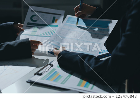 Group of business women working on a financial data expenses document. 128476848