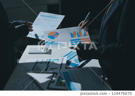 Group of business women working on a financial data expenses document. 128476870