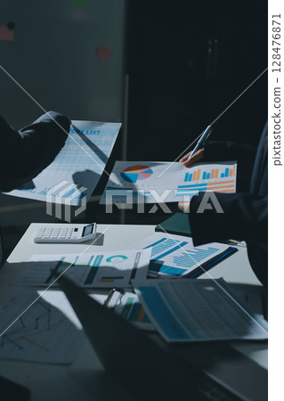 Group of business women working on a financial data expenses document. 128476871