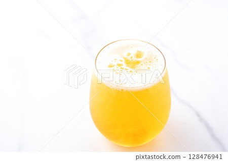 A glass of chilled beer with fine foam A glass of chilled beer with fine foam 128476941