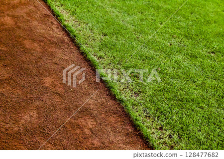 The green artificial grass and reddish brown soil are vibrant and beautiful. The green artificial grass and reddish brown soil are vibrant and beautiful. 128477682