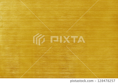 Golden yellow aluminium metal texture background, scratches on polished stainless steel. 128478257