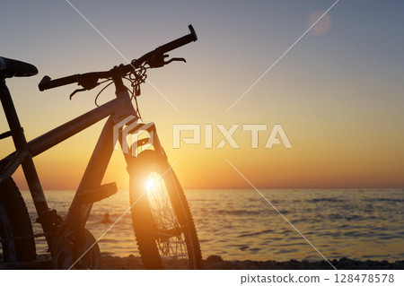 Bicycle by the Seaside at Sunset. Freedom and Tranquility 128478578