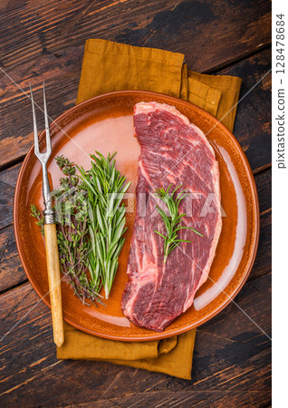 Uncooked sirloin cut, raw beef steak known for its tenderness and robust flavor. wooden background. top view Uncooked sirloin cut, raw beef steak known for its tenderness and robust flavor. wooden background. top view 128478684