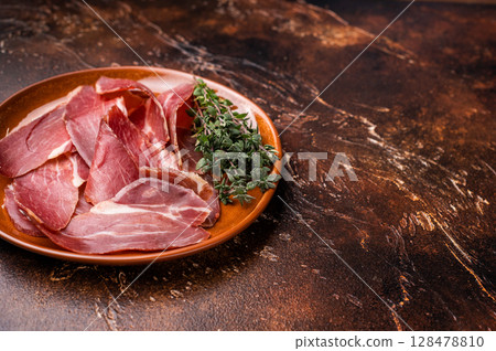 Balkan Prsut prshut, sliced cured pork meat ham on plate. brown background. top view Balkan Prsut prshut, sliced cured pork meat ham on plate. brown background. top view 128478810