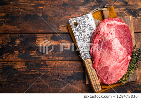Fresh raw boneless beef shank displayed on a wooden cutting board, showcasing its rich color and marbling, perfect for hearty soups and stews. wooden background. top view Fresh raw boneless beef shank displayed on a wooden cutting board, showcasing its rich color and marbling, perfect for hearty soups and stews. wooden background. top view 128478836
