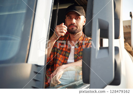 Radio communication. Young truck driver in casual clothes 128479162