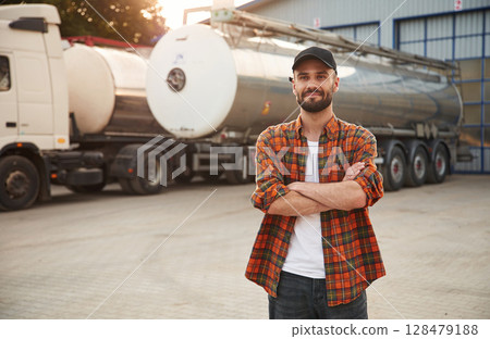 Standing with arms crossed. Young truck driver in casual clothes 128479188