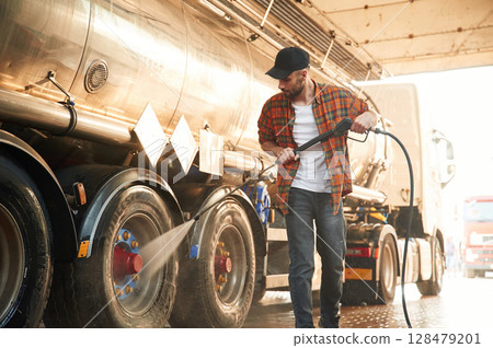 Walking and washing the vehicle. Young truck driver in casual clothes 128479201