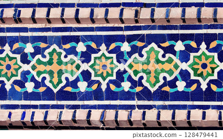 Vertical background with detail of ancient mosaic walls with floral and geometric ornament. Traditional tile decoration on wall, Samarkand, Uzbekistan Vertical background with detail of ancient mosaic walls with floral and geometric ornament. Traditional tile decoration on wall, Samarkand, Uzbekistan 128479441
