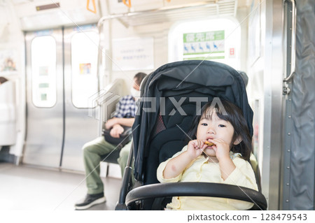 Girl eating snack on train Girl eating snack on train 128479543