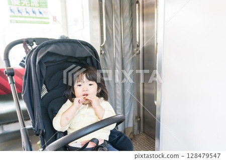 Girl eating snack on train Girl eating snack on train 128479547