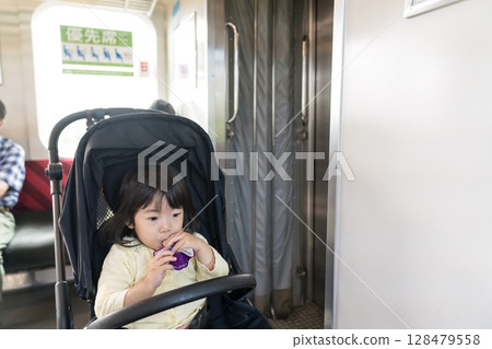 Girl eating snack on train Girl eating snack on train 128479558