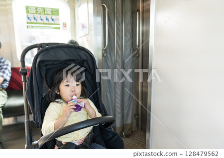 Girl eating snack on train Girl eating snack on train 128479562
