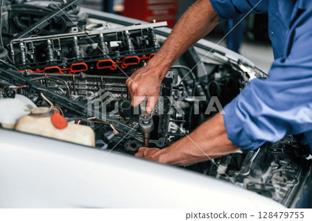 Close up view. Auto mechanic working in garage. Repair service 128479755