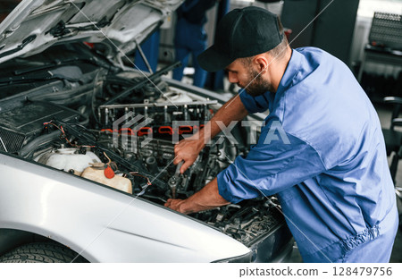 Close up view. Auto mechanic working in garage. Repair service 128479756