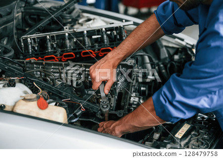 Close up view. Auto mechanic working in garage. Repair service 128479758