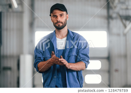 After the job done, standing. Auto mechanic working in garage. Repair service 128479789