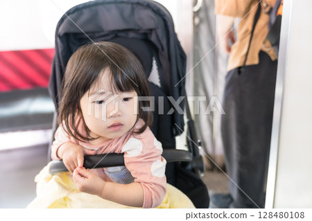 Girl in a stroller on the train 128480108