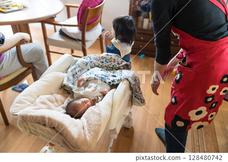 Japanese baby and family sleeping in a baby chair at home Japanese baby and family sleeping in a baby chair at home 128480742
