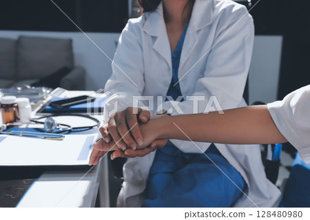 The doctor is checking and encouraging the patient. 128480980