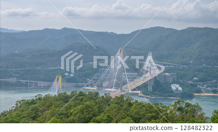 July 13 2025 Suspension Bridge Spanning Scenic Landscape of Hills and Waterway 128482322