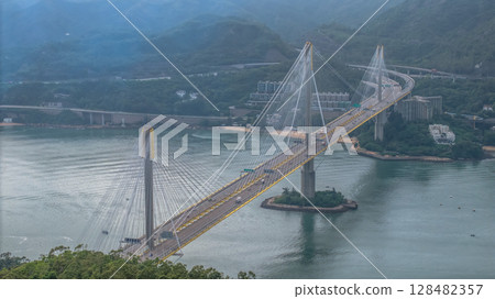 July 13 2025 Suspension Bridge Spanning Scenic Landscape of Hills and Waterway 128482357