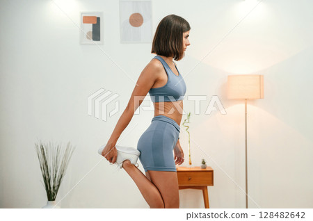 Pretty woman in sportive clothes have fitness day indoors 128482642