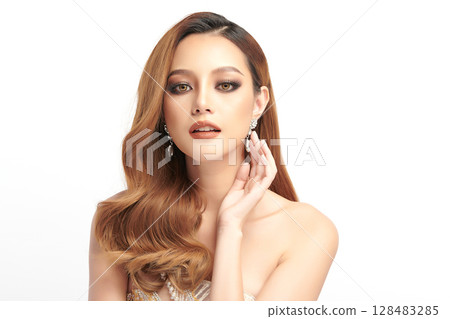 A beautiful young Asian woman with clean, fresh skin against a white background. Skincare, facial treatment, cosmetology, beauty, and spa. An elegant portrait of an Asian woman. A beautiful young Asian woman with clean, fresh skin against a white background. Skincare, facial treatment, cosmetology, beauty, and spa. An elegant portrait of an Asian woman. 128483285
